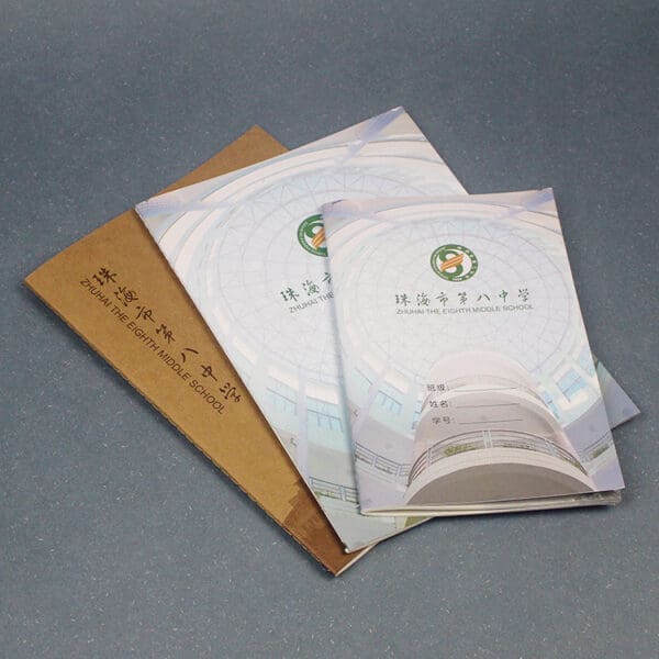Elegant architectural design brochures in blue and white with a textured brown folder.