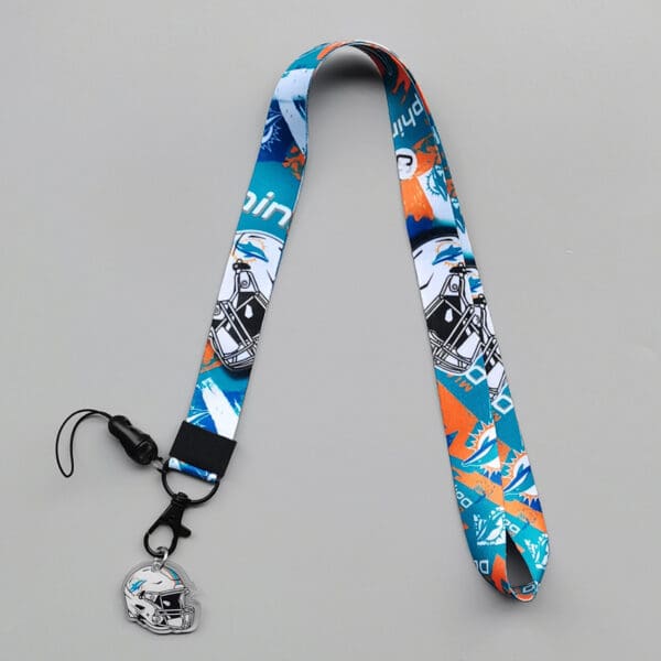 Vibrant sports lanyard in teal and orange with helmet charm, perfect for team spirit.