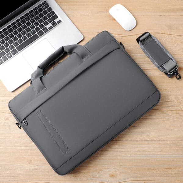 Modern gray laptop bag on wood, paired with a silver laptop and white mouse.