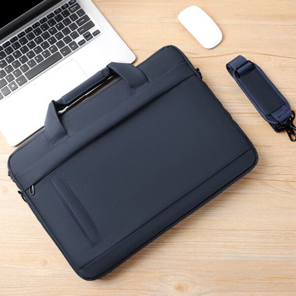 Stylish navy laptop bag and white mouse enhance modern corporate workspace elegance.