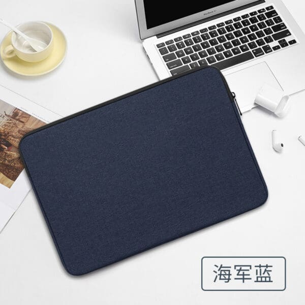Navy blue laptop sleeve on a modern desk, perfect for professional environments and productivity.