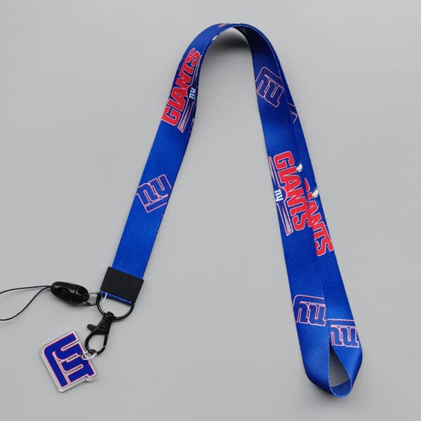 Vibrant blue New York Giants lanyard with secure clasp and logo charm for fans.