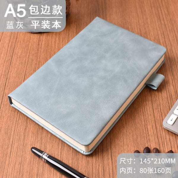Stylish light blue A5 notebook and pen, perfect for corporate gifts and professional creativity.