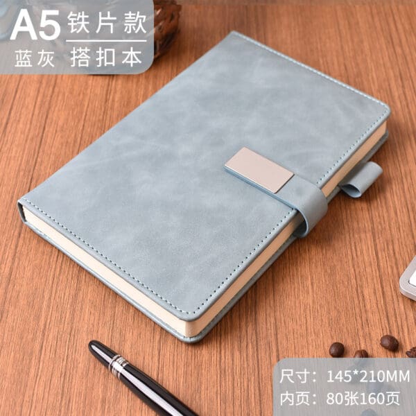 Elegant light blue A5 notebook with metallic clasp, ideal for corporate gifting and creativity.