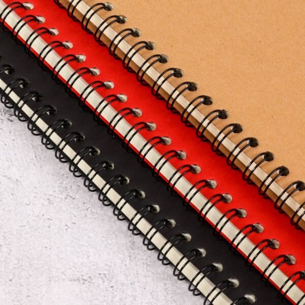Colorful spiral-bound notebooks with kraft, red, and black covers, ideal for corporate gifts.
