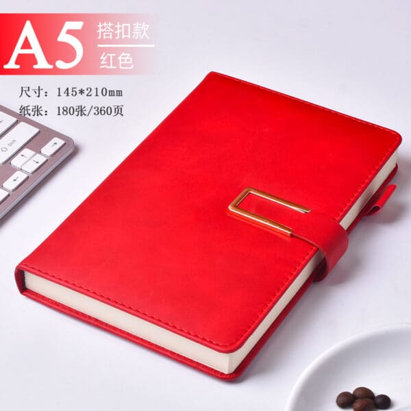 Elegant red leather A5 notebook with gold clasp, perfect for corporate gifts and stylish workspaces.