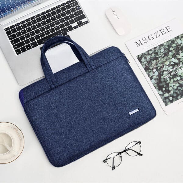 Chic navy laptop bag in a modern workspace with ergonomic accessories for productivity and style.